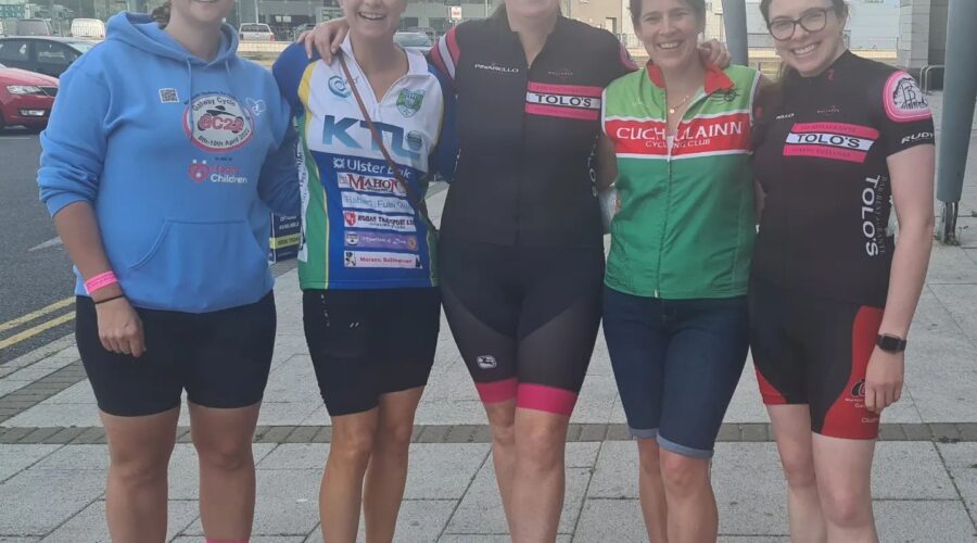 Five women smile for photo in bike gear.