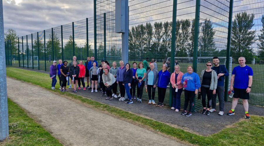 Muirhevnamor Hub - Couch to 5K group post along astroturf pitch.
