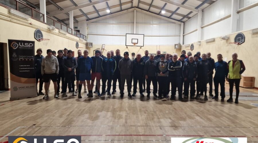 Men on the Move - Group of men pose for picture in a gymnasium.