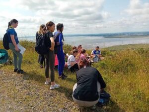 Group of girls stop for a snack on trail.