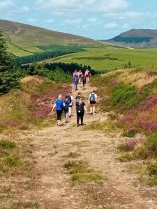Group of girls climbing a summit trail.