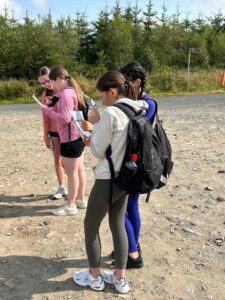 Group of four girls check maps.