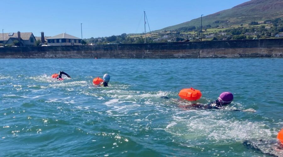 Girls do breast stroke in open water.