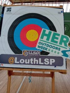 Archery board that has signage for Her Outdoors Week and Louth LSP.