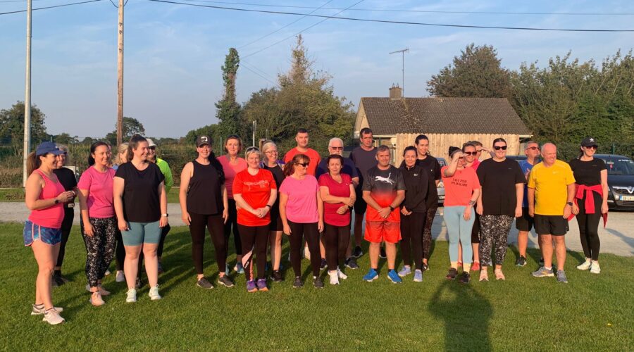 Moneymore Hub - Couch to 5K in Drogheda shows group of men and women posing on the grass.