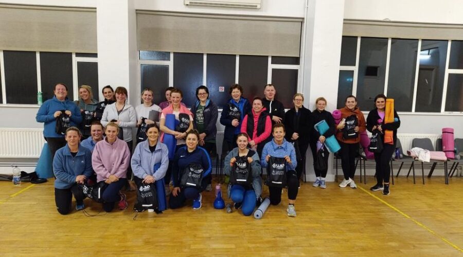 Moneymore Hub - Bootcamp in Drogheda shows group of people with yoga mats posing in a gym.