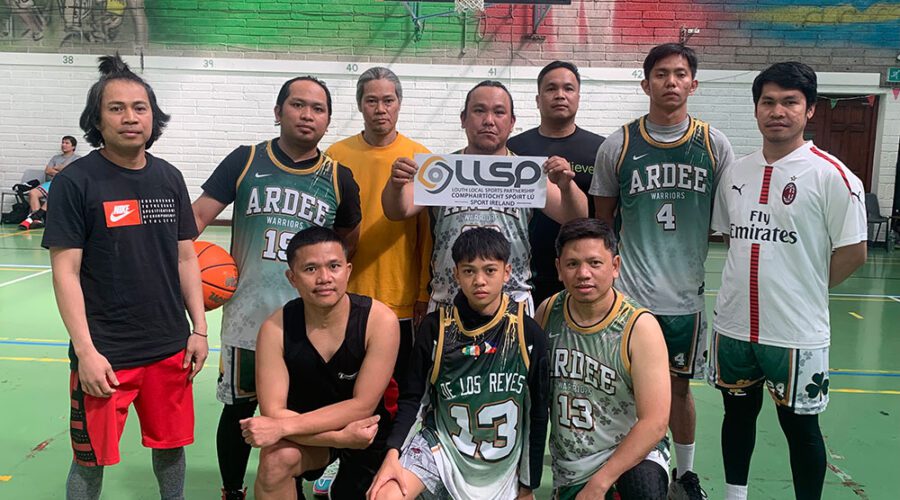 Group of men in basketball attire holding sign for LLSP.
