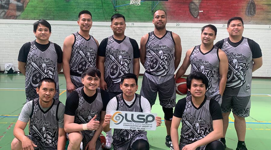 Group of men in basketball attire holding sign for LLSP.
