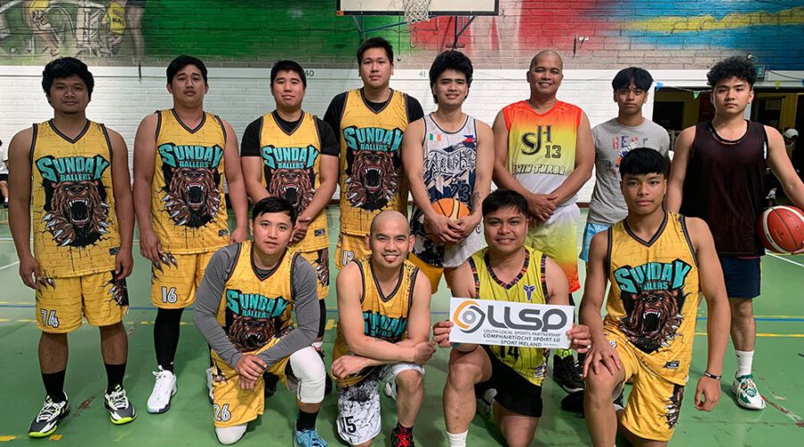 Group of men in basketball attire holding sign for LLSP.