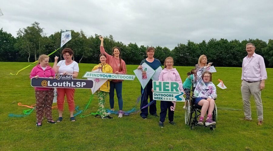 Group of people have fun with kites in the park.