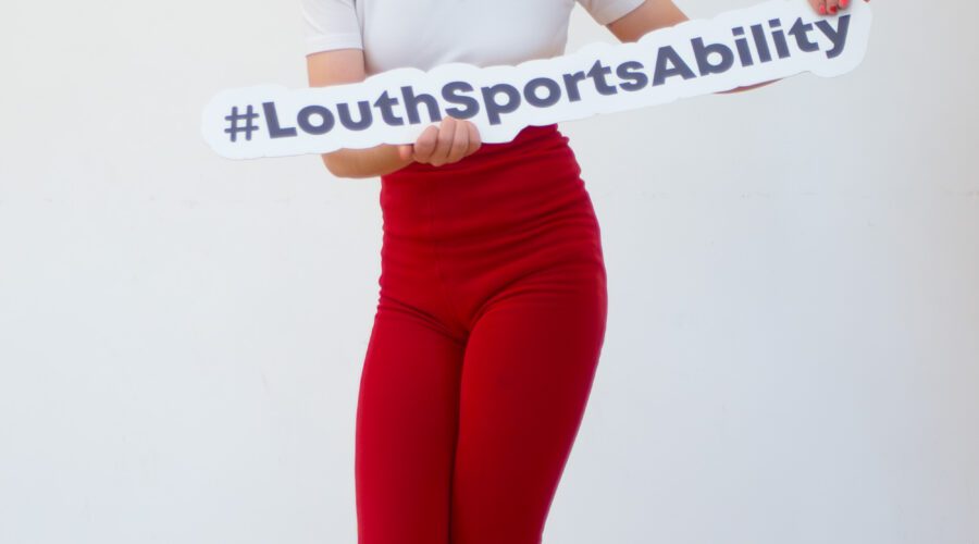 Young girl holds sign for #LouthSportsAbility.