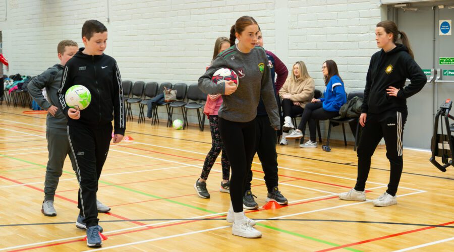 Group of children play in gymnasium.