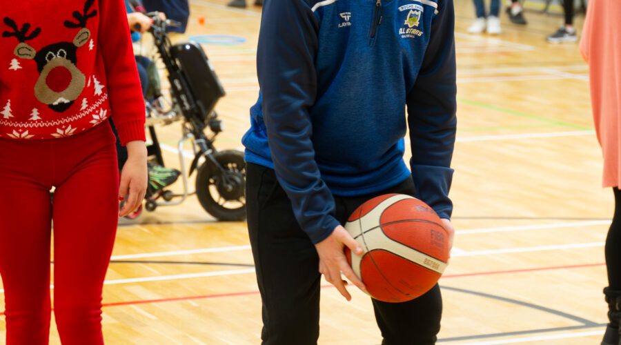Young boy begins to throw basketball.