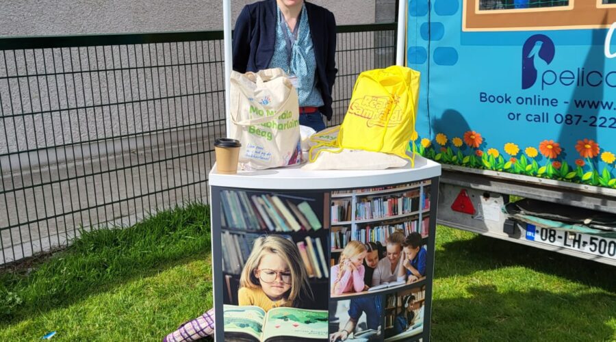 Woman stands at a stall for Louth Library Service.