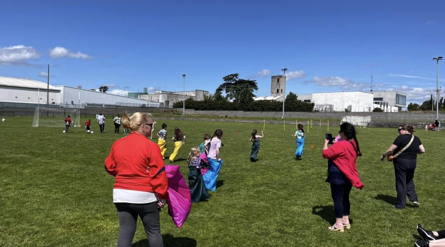 Young children partake in a sack race.